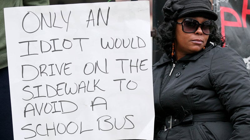 In 2012, a Cleveland woman arrested for a traffic infraction was ordered to stand for 2 days holding a sign that read "Only an idiot would drive on the sidewalk to avoid a school bus."